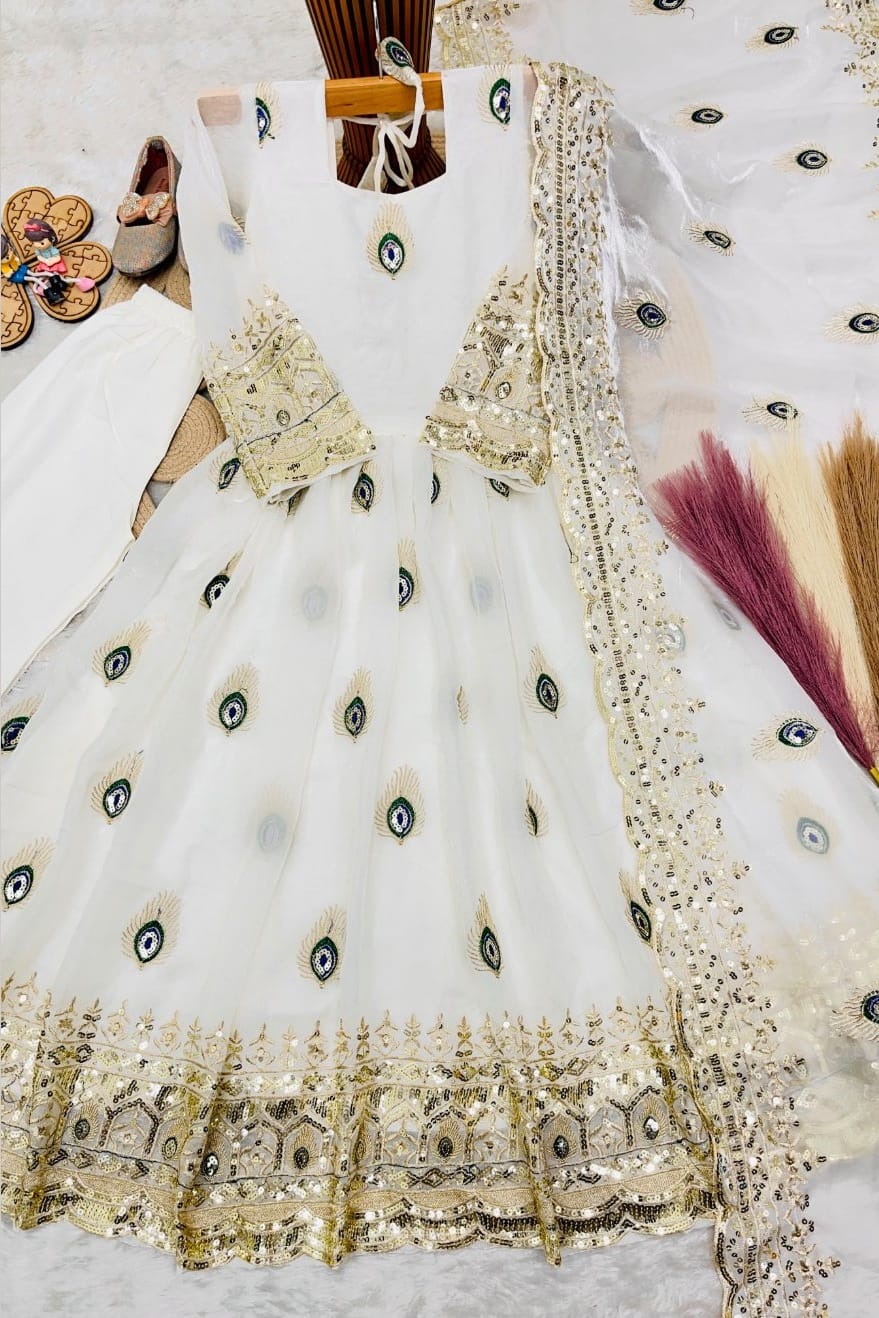 White childrens indian costume anarkali set for girls flat lay showing the embroidered top, cotton pant and fendy silk dupatta.