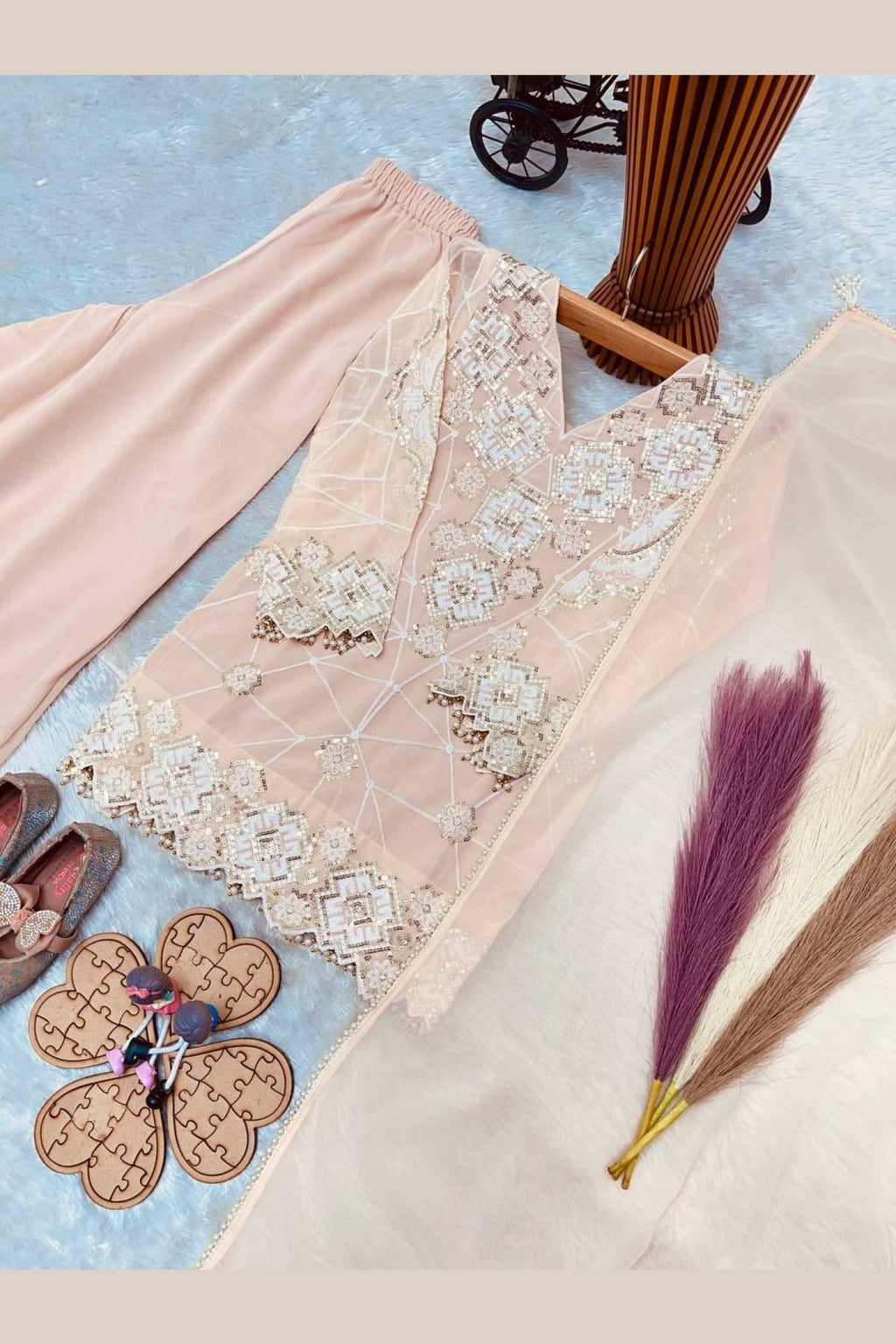 Peach kids kurta set on model, side view showing sequin and thread detailing.