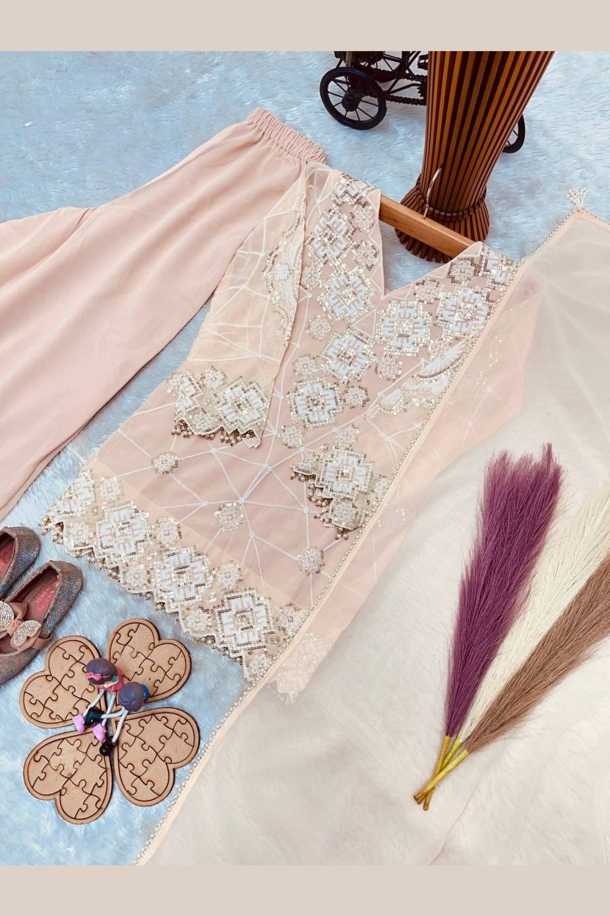 Peach kids kurta set on model, side view showing sequin and thread detailing.
