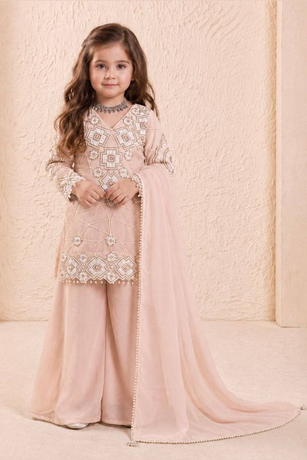 Peach childrens indian outfits girls kurta set, full front view on model, sequins and thread work on georgette.