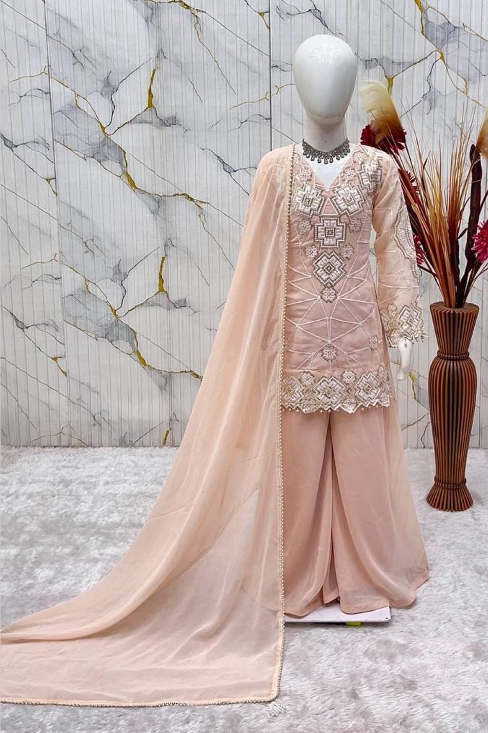 Peach ethnic kidswear kurta set for girls, three-quarter view, embroidered neckline on georgette.