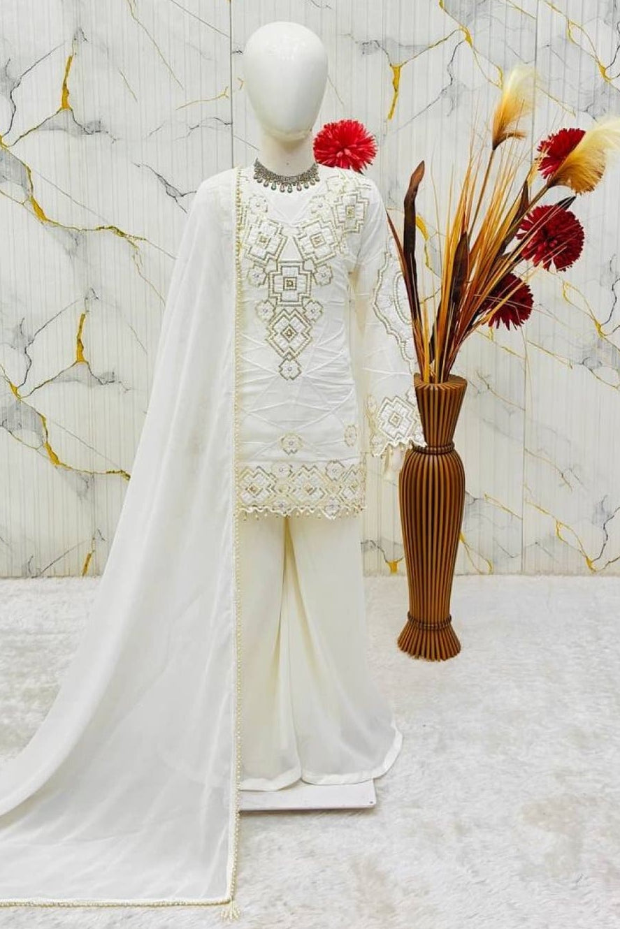 White ethnic kidswear kurta set for girls, three-quarter front view, showing embroidered neckline detail.