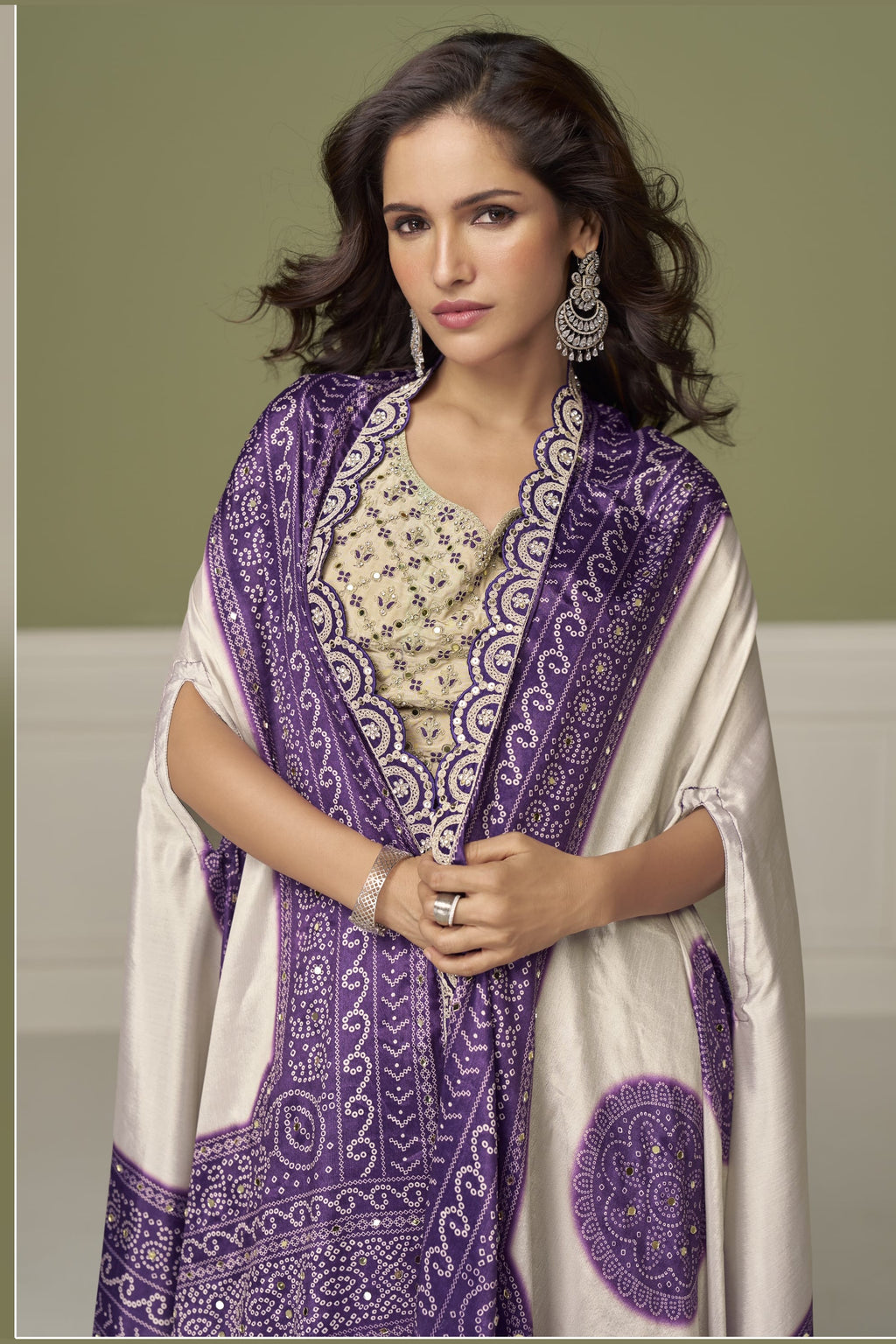 Close-up of a purple engagement dresses for women plazo blouse in chinon silk with embroidery and print work on the sweetheart neckline.