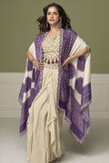 Woman wearing a purple engagement dresses for women plazo and blouse set in chinon silk with embroidery and print work, full-length front view.