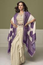 Woman wearing a purple engagement dresses for women plazo and blouse set in chinon silk with embroidery and print work, full-length front view.