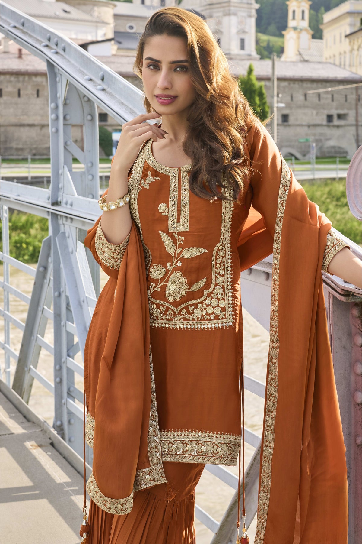 Waist-down view of the sharara and kurta hem of the Rust sharara suit pakistani, displaying the flared sharara and embroidered kurta border.