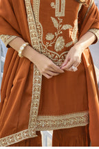 Close-up of the embroidery work on the pure silk kurta of the Rust indian sharara, showing the embroidery detailing on the pure silk fabric.