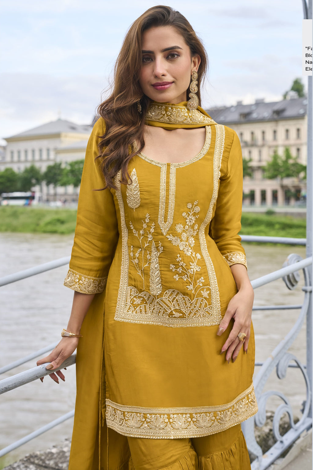 Model wearing a Mustard Yellow sharara suit with embroidered pure silk kurta and dupatta, full-length side view.