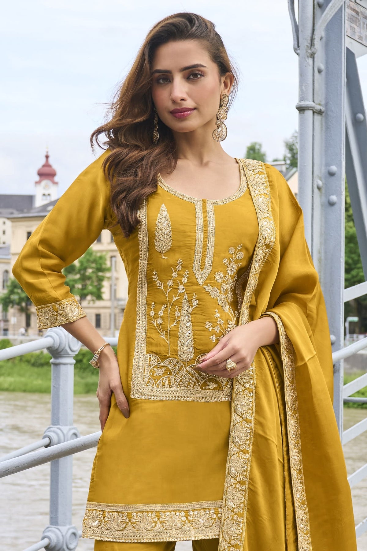 Waist-down view of the sharara and kurta hem of the Mustard Yellow indian sharara suit, displaying the flared sharara and embroidered kurta border.
