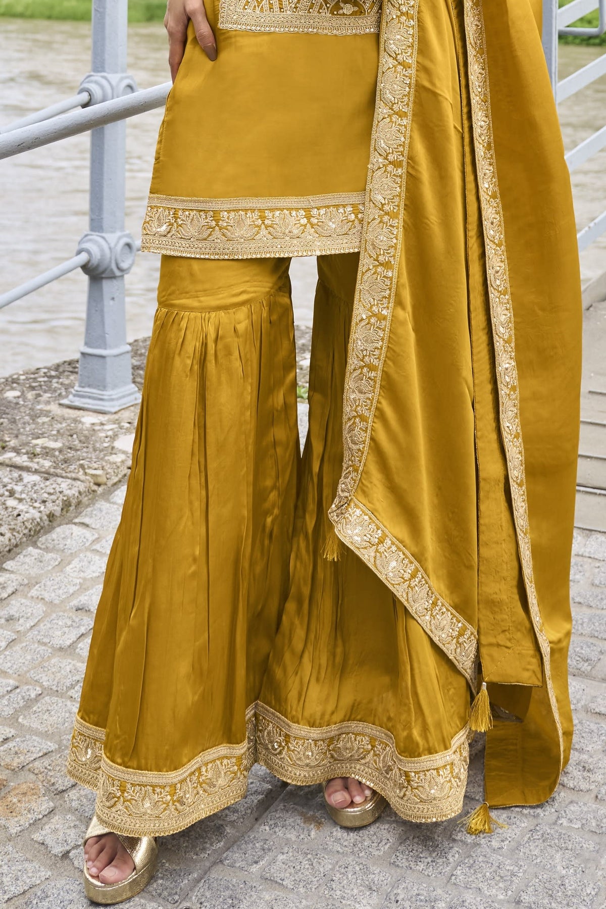 Close-up of the embroidery work on the pure silk kurta of the Mustard Yellow sharara suit for wedding, showing the embroidery detailing on the pure silk fabric.