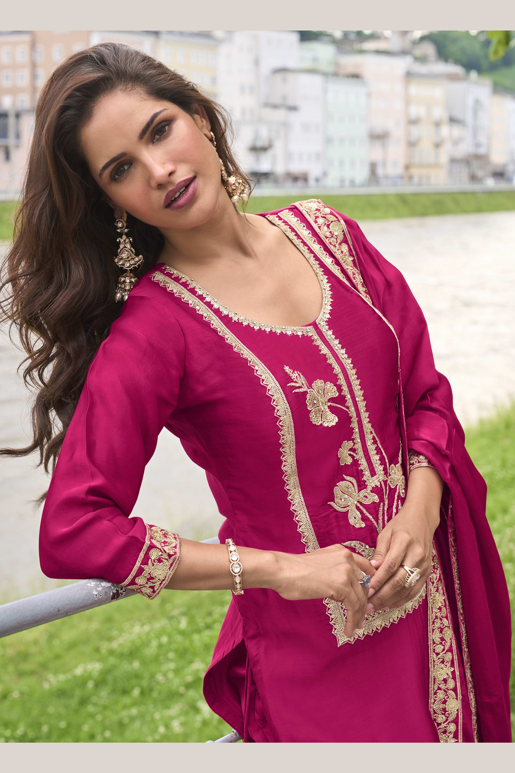 Waist-down view of the sharara and kurta hem of the Reddish Pink punjabi sharara suit, displaying the flared sharara and embroidered kurta border.