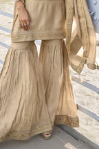 Waist-down view of the sharara and kurta hem of the Beige sharara suit pakistani, displaying the flared sharara and embroidered kurta border.