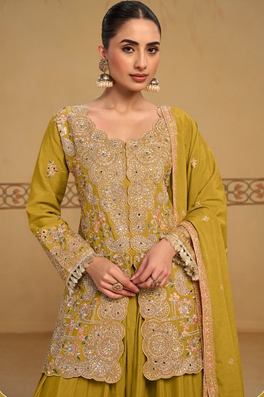 Close-up view of the neckline embroidery of the Mustard Yellow palazzo suit, showing the embroidered neckline and sleeve detailing on chinon silk.