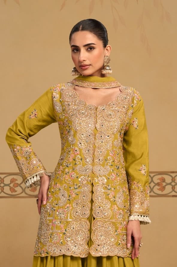 Torso view showing the thread and sequins embroidery of the Mustard Yellow palazzo kurta set, highlighting the thread and sequins work on the chinon silk kameez.