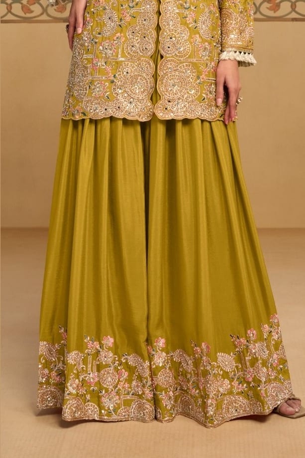 Waist-down view of the palazzo and kameez hem of the Mustard Yellow ladies palazzo suit, displaying the flared palazzo and embroidered kameez hem.