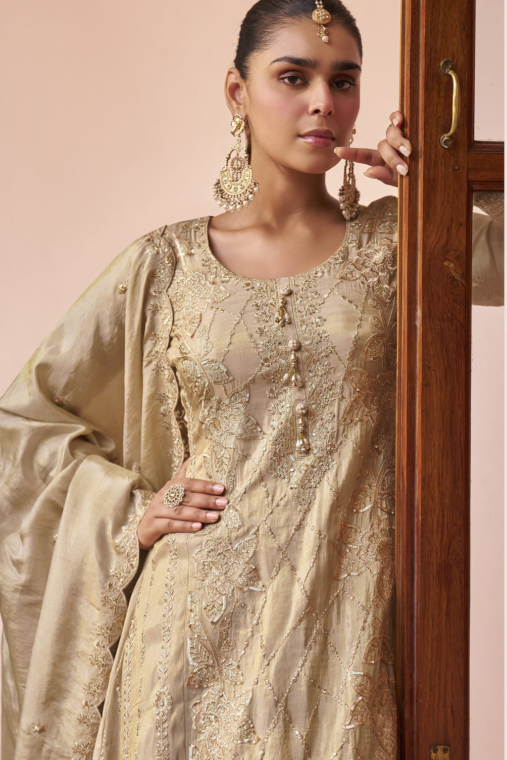 Close-up of the beige palazzo kurta set showing hand work, thread embroidery and sequin detailing on the simmer silk neckline and sleeves.
