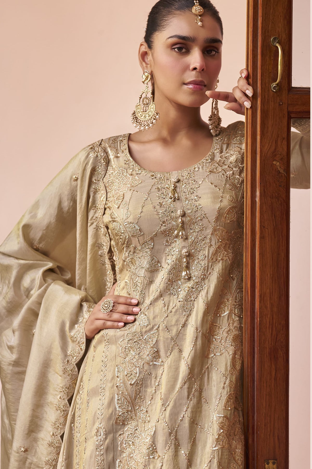 Close-up of the beige palazzo kurta set showing hand work, thread embroidery and sequin detailing on the simmer silk neckline and sleeves.