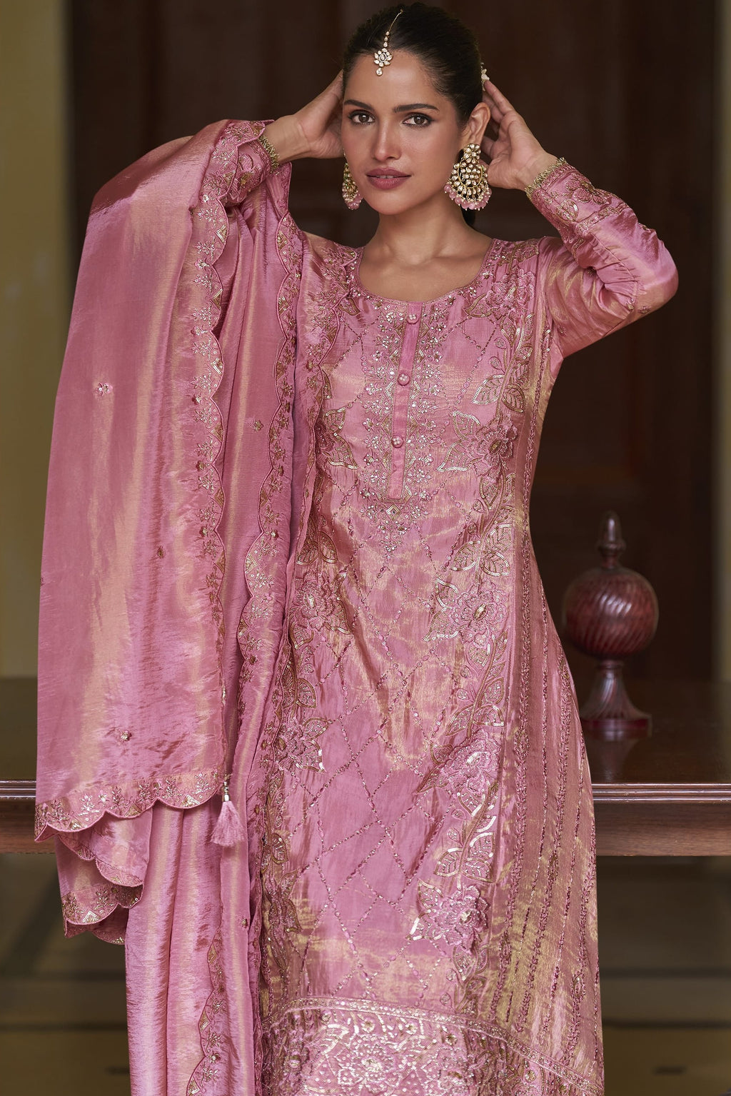 Portrait view of the light pink palazzo kurta set highlighting the hand work and sequins embroidery on the simmer silk neckline.