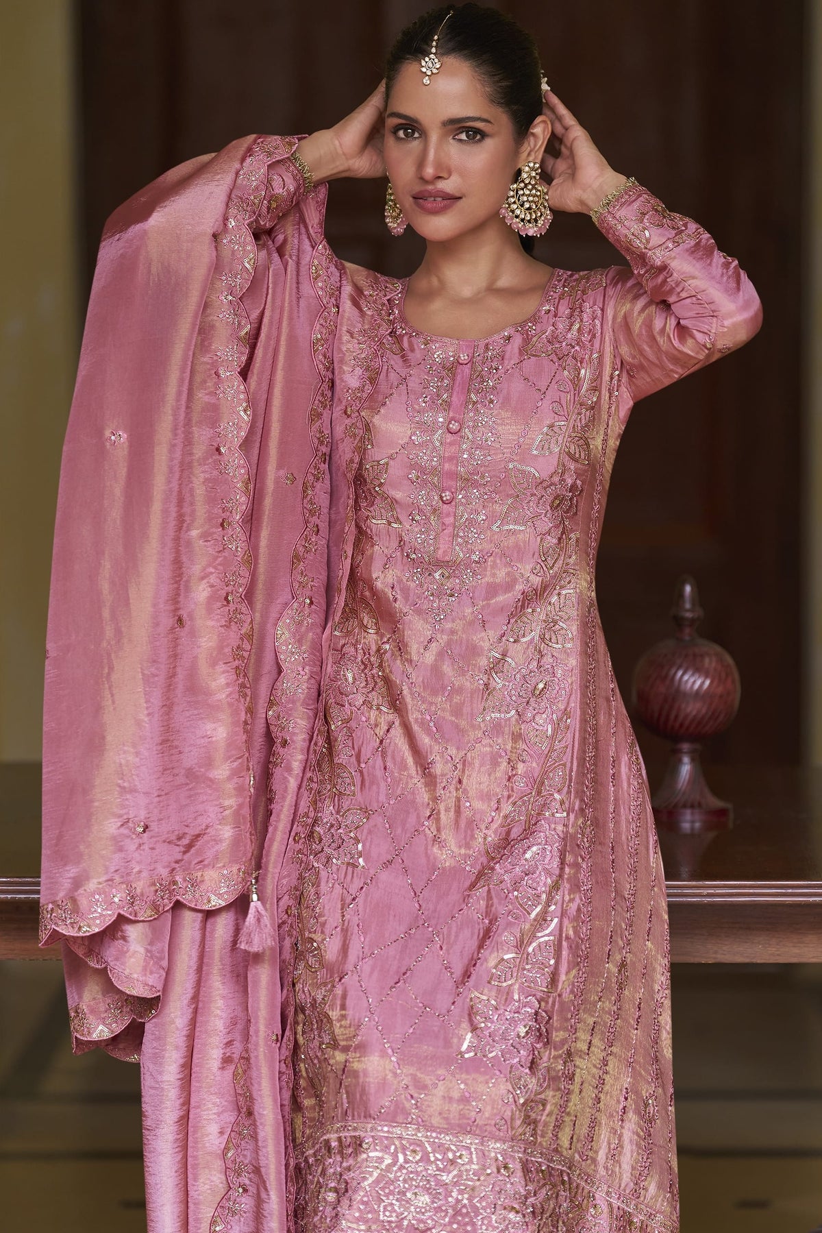 Portrait view of the light pink palazzo kurta set highlighting the hand work and sequins embroidery on the simmer silk neckline.