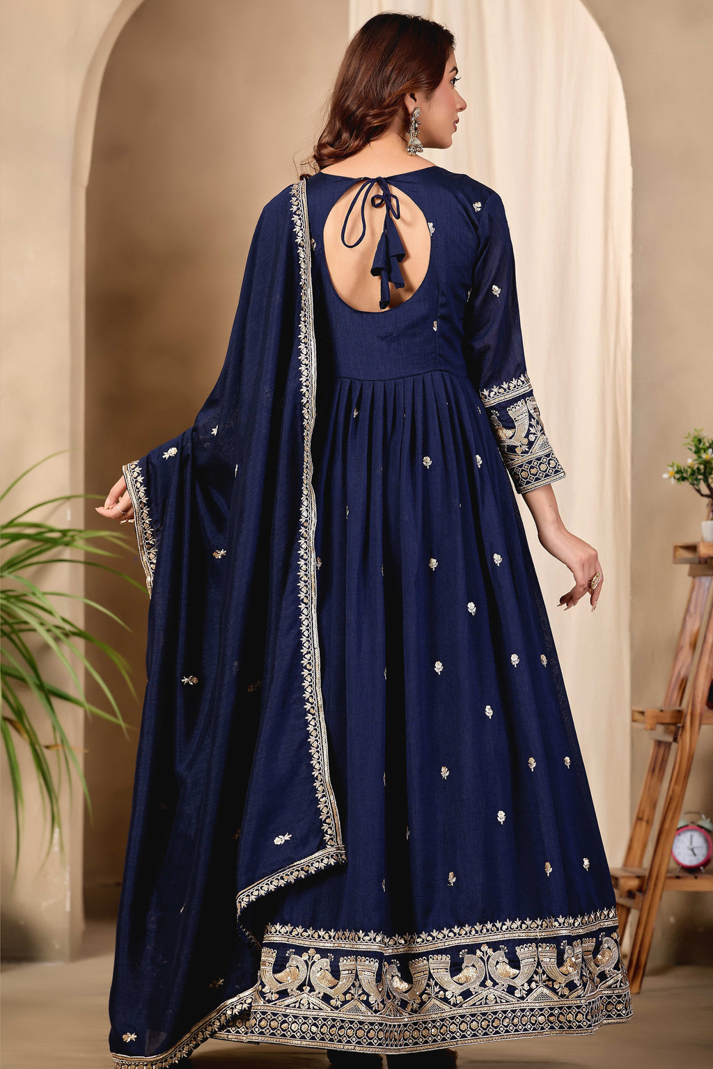 Full-length back view of a navy blue anarkali dress for wedding in art silk with a keyhole back neckline with dori tie, sequin and thread embroidery.