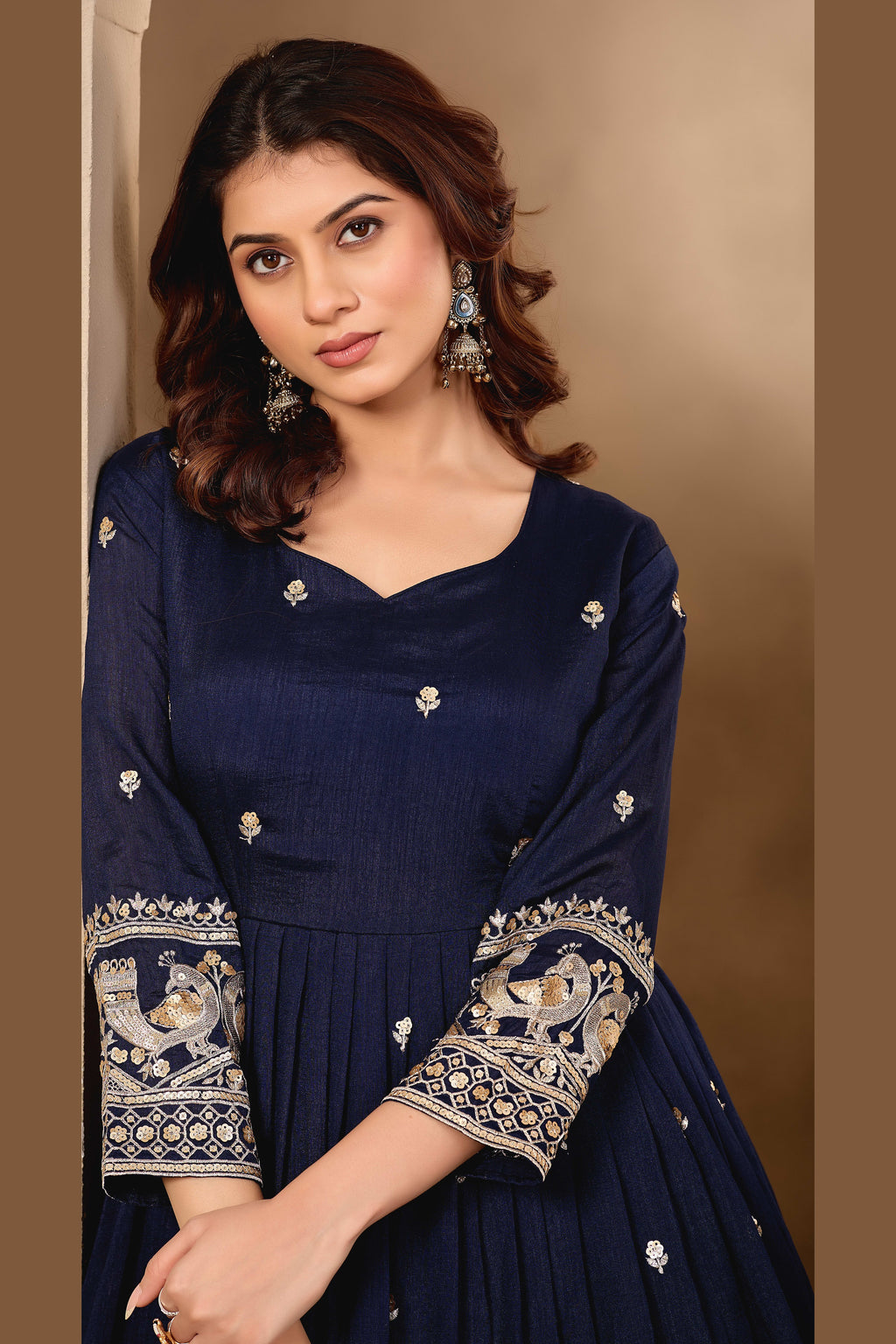 Close-up of a navy blue anarkali gown bodice in art silk with sequin and thread embroidery on the neckline and three-quarter sleeves.