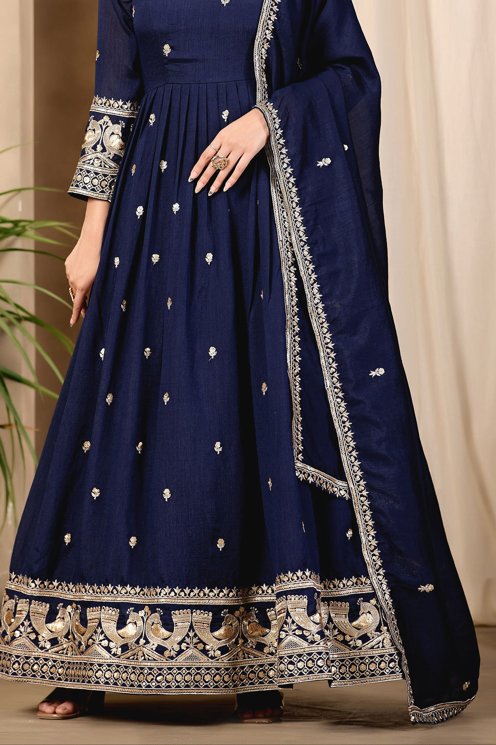 Full-length front view of a navy blue anarkali gown in art silk with sequin and thread embroidery on the bodice and hem, crepe churidar and embroidered dupatta.