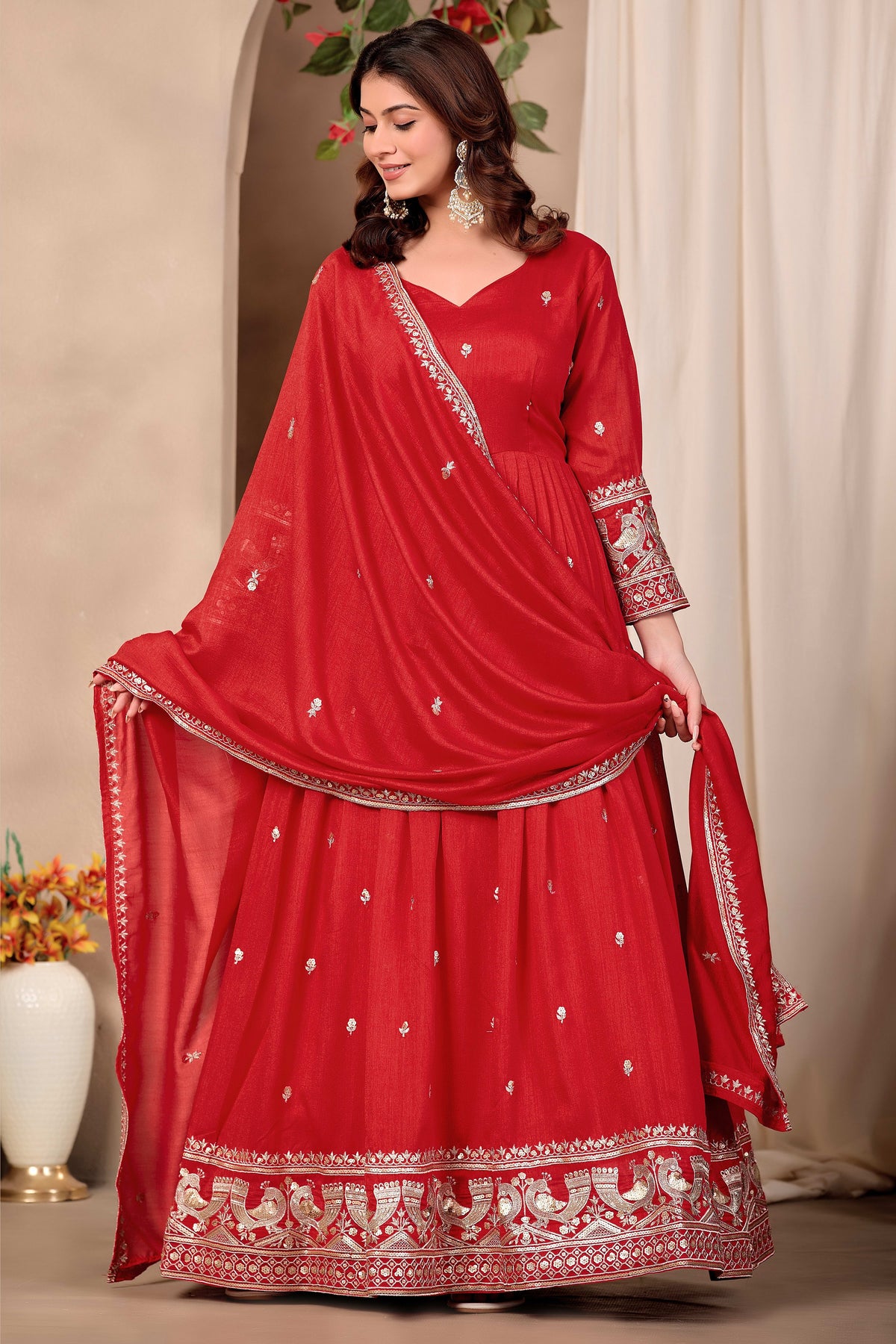 Woman wearing red indian wedding guest dresses style anarkali suit in art silk with sequin and thread embroidery, crepe churidar and embroidered dupatta, full-length front view.