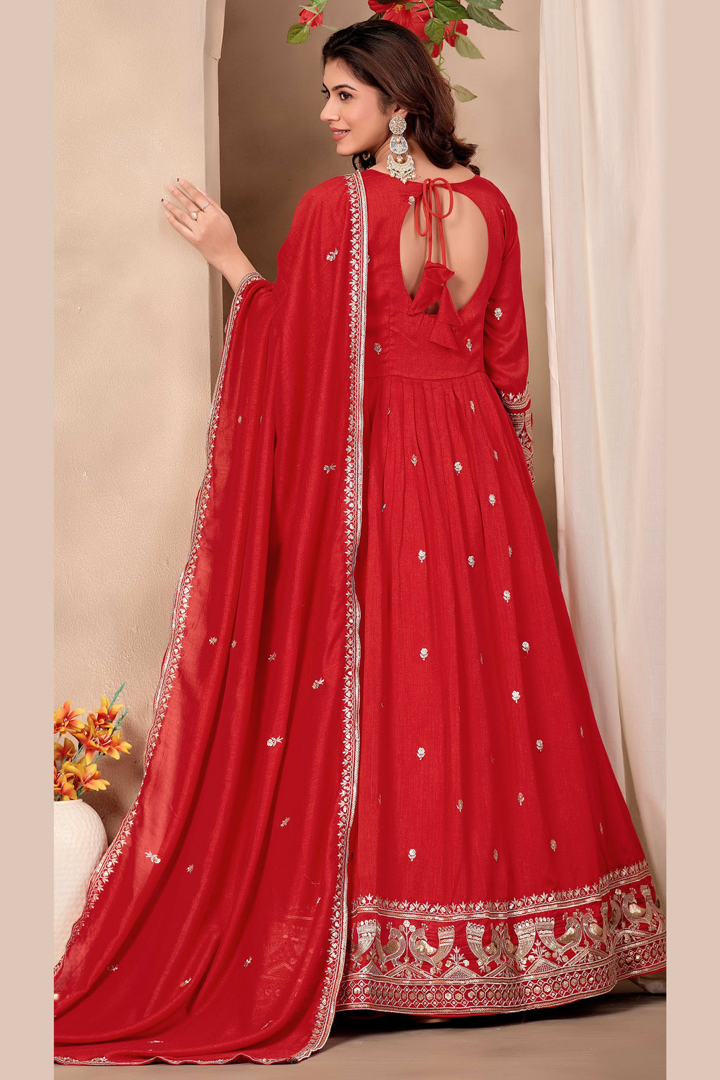 Full-length back view of a red indian wedding guest dresses style anarkali in art silk with a keyhole back neckline with dori tie, sequin and thread embroidery.