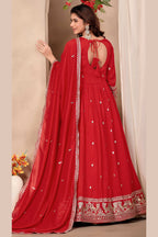 Full-length back view of a red indian wedding guest dresses style anarkali in art silk with a keyhole back neckline with dori tie, sequin and thread embroidery.
