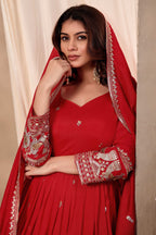 Close-up of a red anarkali gown bodice in art silk with sequin and thread embroidery on the neckline and three-quarter sleeves.