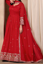 Full-length front view of a red anarkali gown in art silk with sequin and thread embroidery on the bodice and hem, crepe churidar and embroidered dupatta.