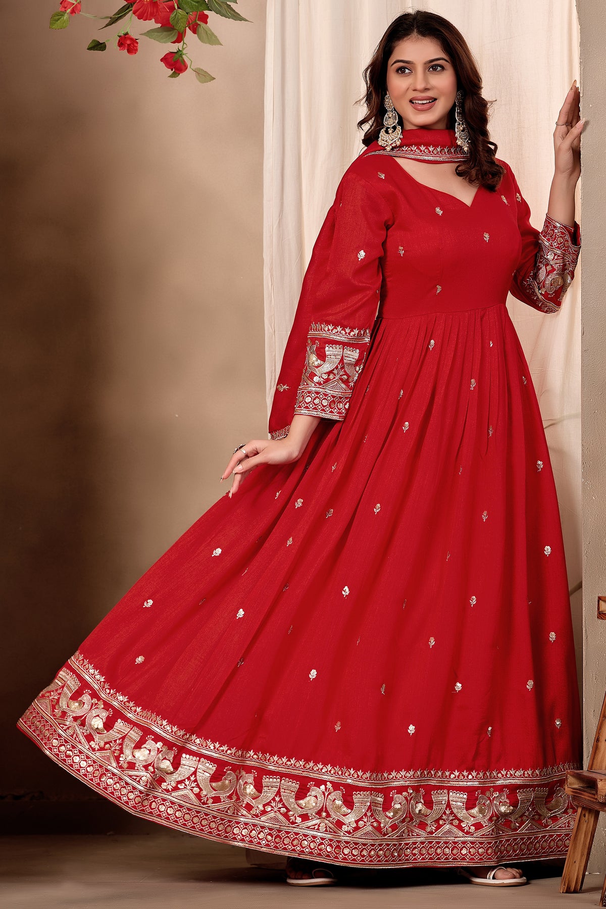 Full-length front view of a red engagement dresses for women style anarkali gown in art silk with sequin and thread embroidery and a twirling flared skirt.