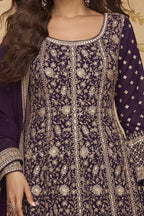 Neckline-to-waist close view of a purple anarkali gown for wedding in georgette with heavy gold zari embroidery and full sleeves.