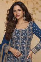 Close-up front view of a blue anarkali dress for wedding in georgette with gold zari floral embroidery, round neckline and embroidered full sleeves.