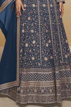 Waist-to-hem view of a blue georgette anarkali dress with gold zari floral embroidery, wide embroidered border and matching dupatta.