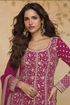Close-up front view of a dark pink anarkali dress for wedding in georgette with gold zari floral embroidery, round neckline and embroidered full sleeves.