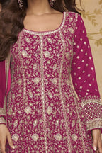 Neckline-to-waist close view of a dark pink wedding anarkali dress in georgette with heavy gold zari embroidery and full sleeves.