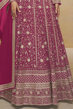 Waist-to-hem view of a dark pink pakistani anarkali suit in georgette with gold zari floral embroidery and wide embroidered border.