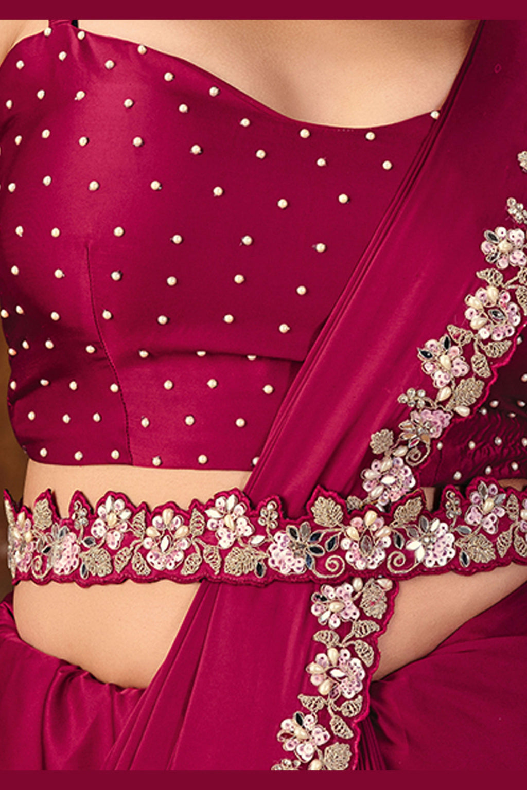 Dark red embroidered saree drape closeup showing sequin border work