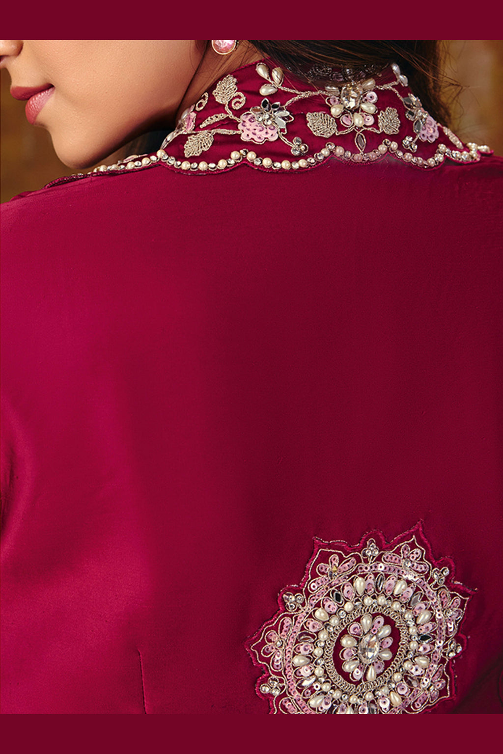 Embroidered dark red saree with mirror-work jacket, model posing in studio
