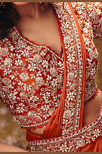 Designer rust saree side view with flowing satin drape