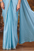 Designer light blue saree side view with flowing two-tone drape