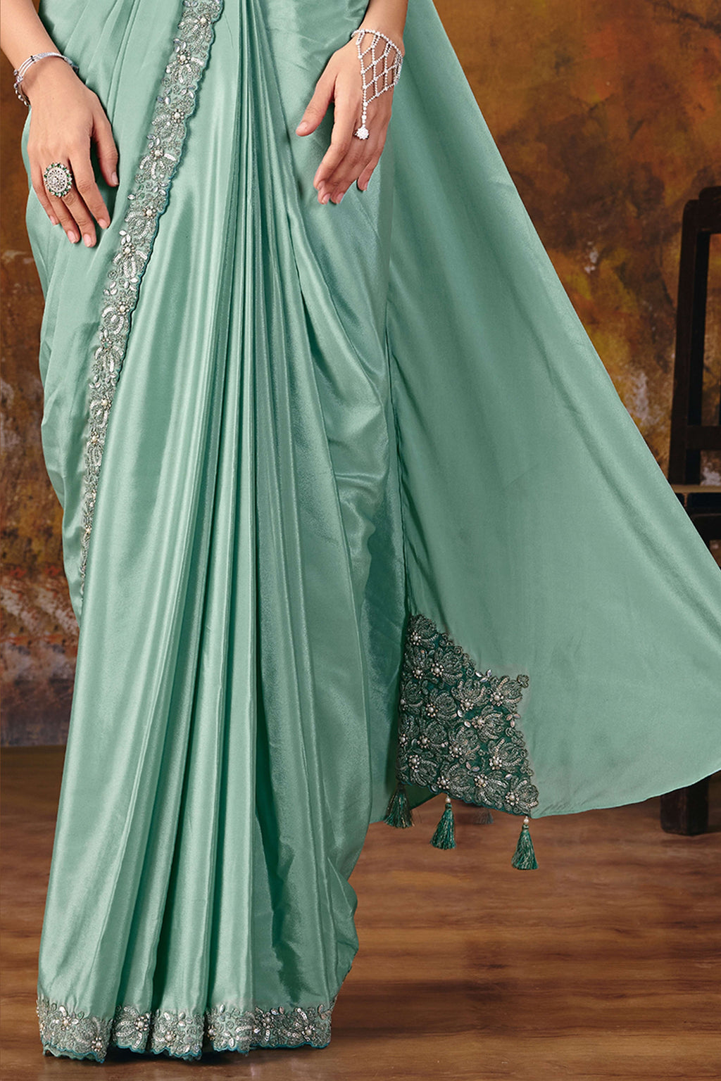 Sea green embroidered saree lower drape closeup with pearl border