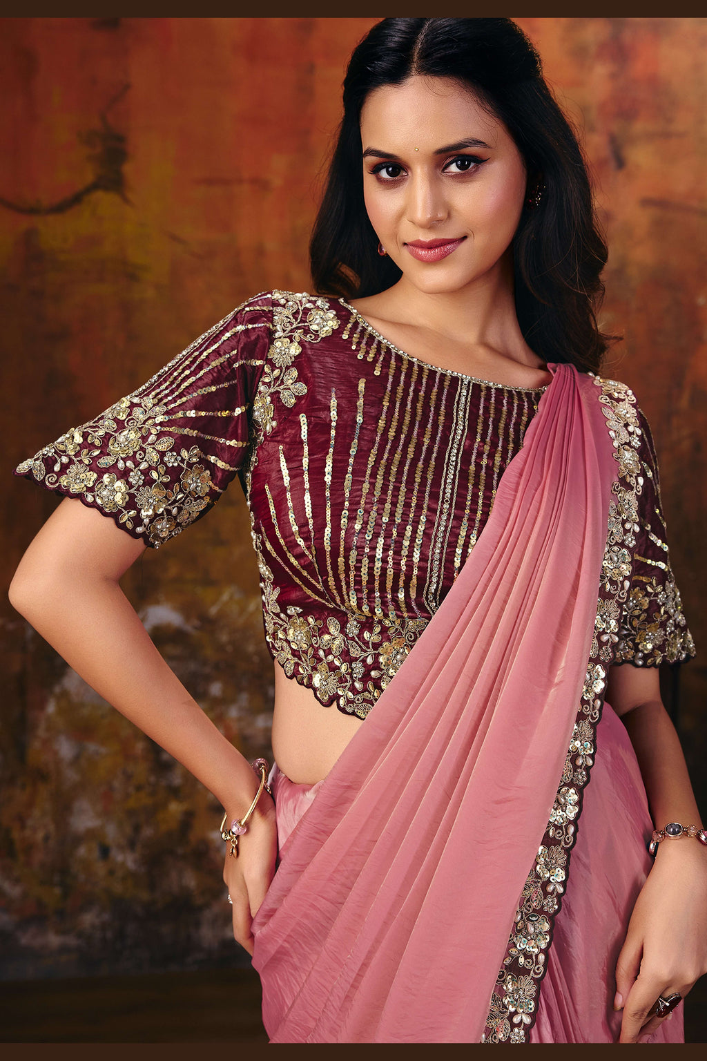 Pink embroidered saree blouse closeup showing sequin and pearl work
