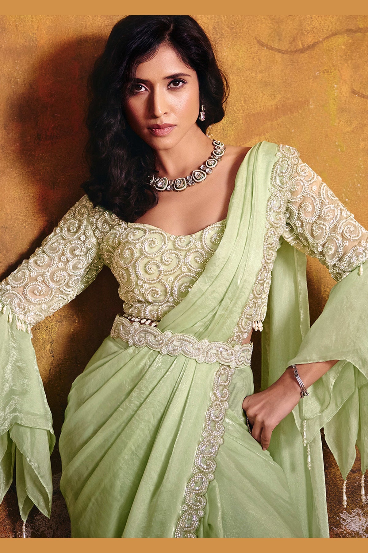 Mint green embroidered saree blouse closeup with sequin and bead detail