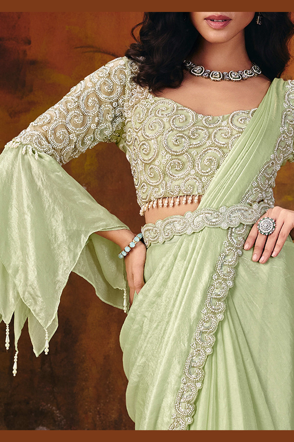 Designer mint green saree side view with flowing two-tone drape
