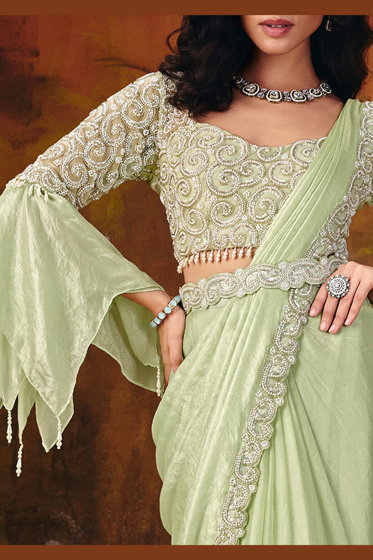 Designer mint green saree side view with flowing two-tone drape