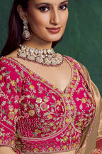 Hot pink designer saree, upper-body closeup of the bead work on the blouse and embroidered border