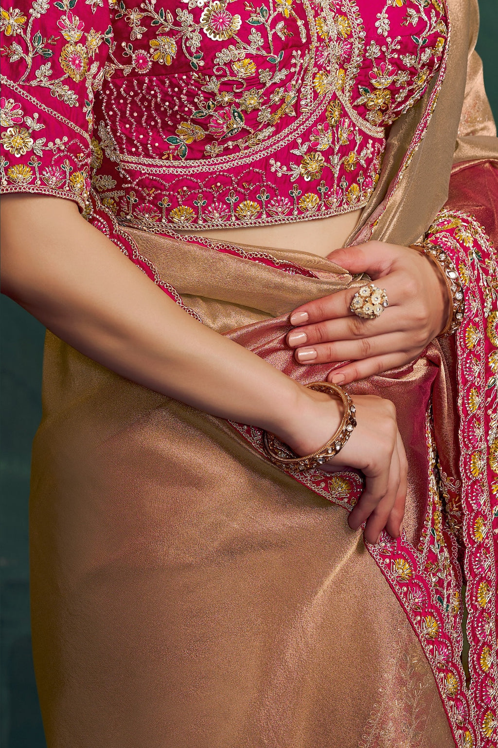 Hot pink embroidered saree, waist-down view of the shimmering pleats and drape
