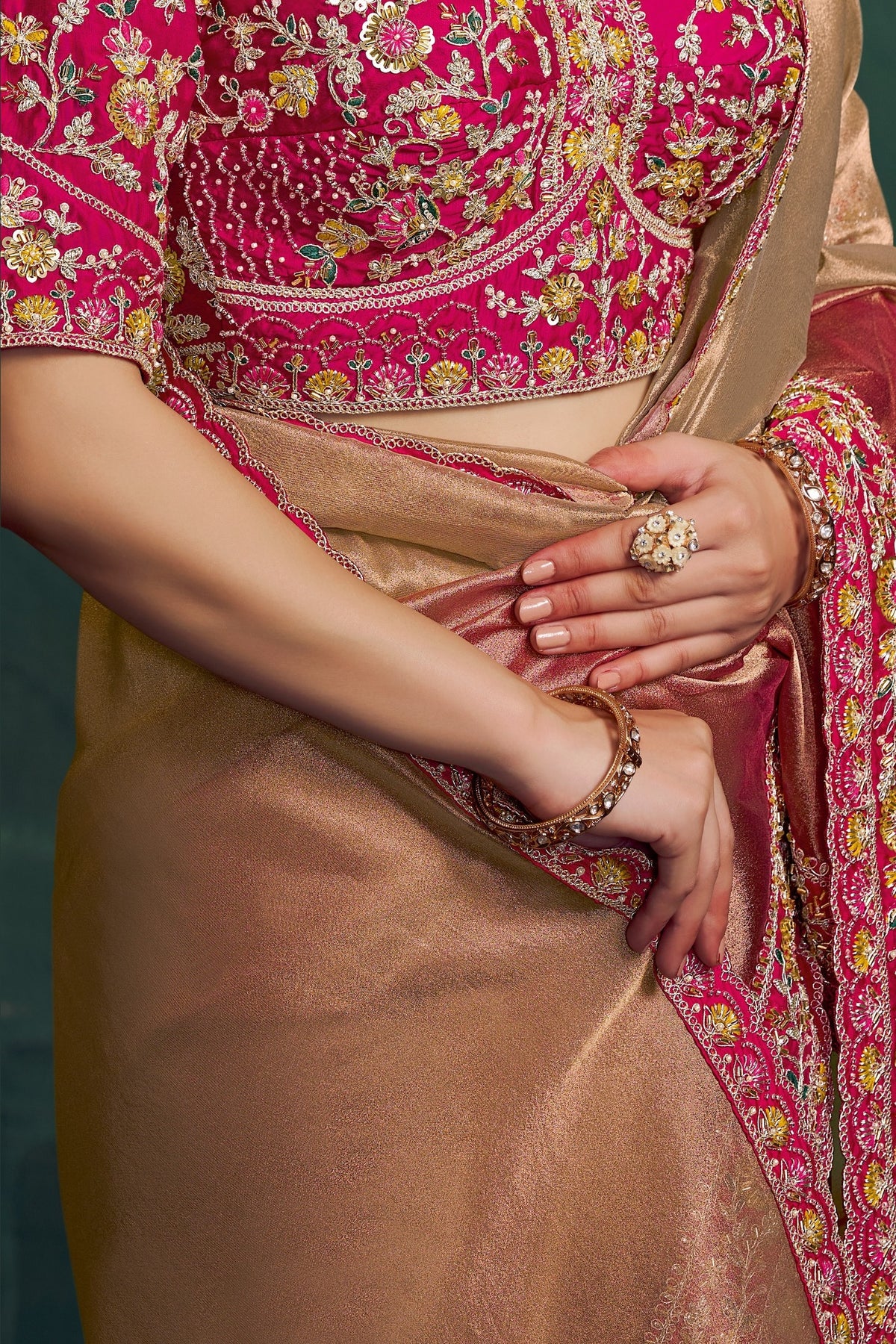 Hot pink embroidered saree, waist-down view of the shimmering pleats and drape
